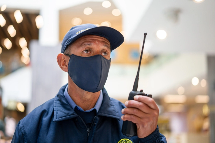 A security professional communicating by radio